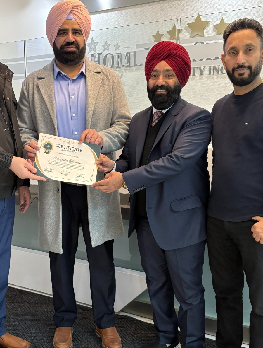 Rupinder Tiwana receiving a Certificate of Appreciation at HomeLife SilverCity Realty